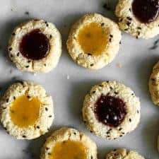Easy Gluten-Free Coconut Thumbprint Cookies that are made with less than 10 ingredients! by Lisa Lin of clube.futebolmilionario.com