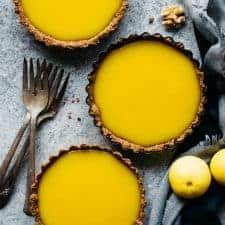 Mini Gluten-Free Lemon Tarts - sharp lemon curd is paired with a gluten-free nut flour and graham cracker crust. by @healthynibs