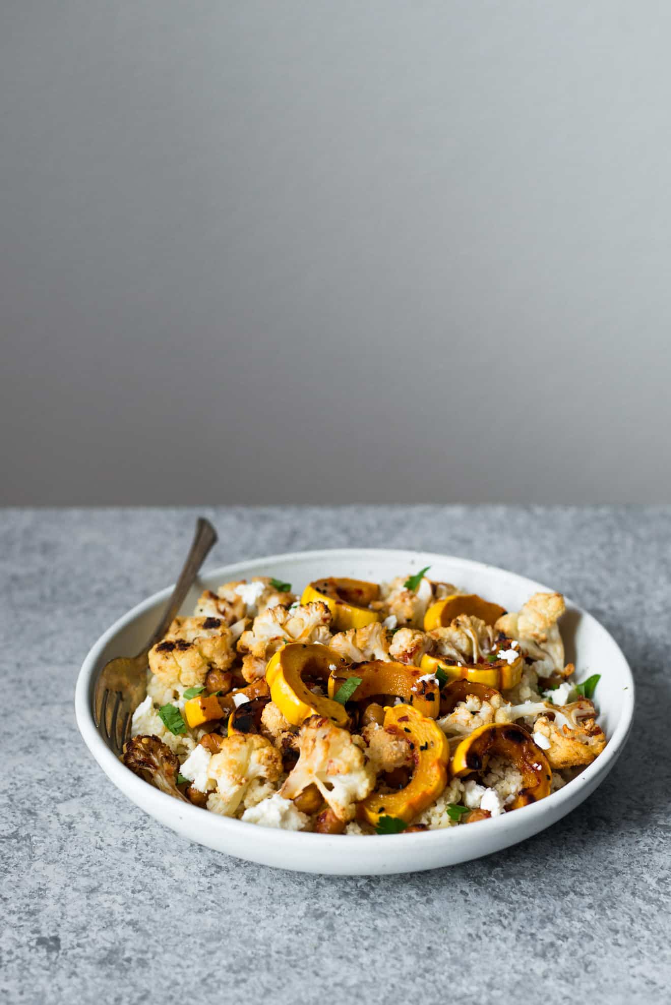 This Harissa Roasted Cauliflower with Delicata Squash & Chickpeas is a healthy, gluten-free weeknight dinner! Made with just 7 ingredients!