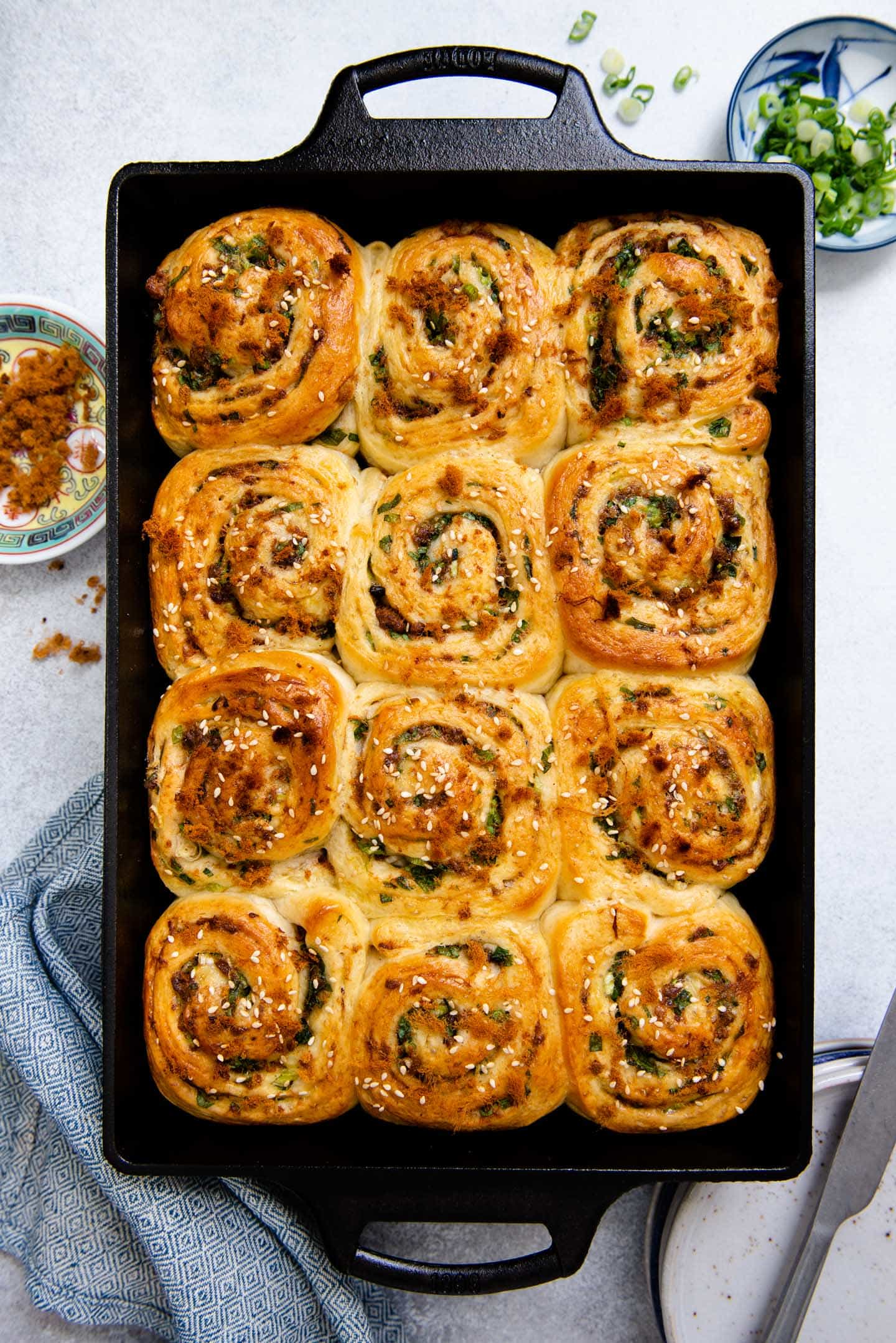 Photo of scallion and pork floss rolls in a cast iron casserole pan