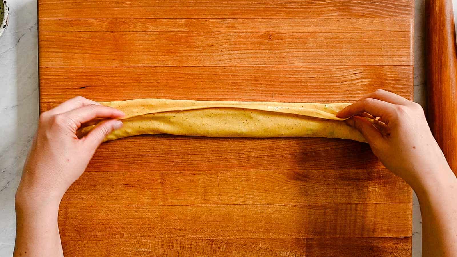 Folding up dough into thinner rectangle