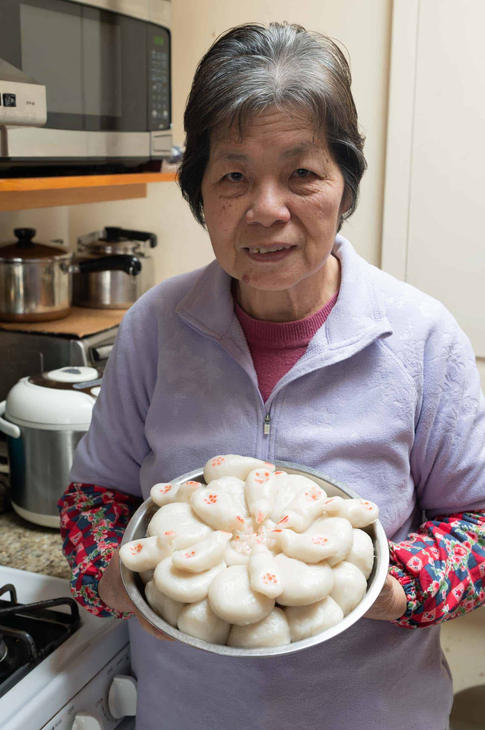 Mama Lin holding rice cakes