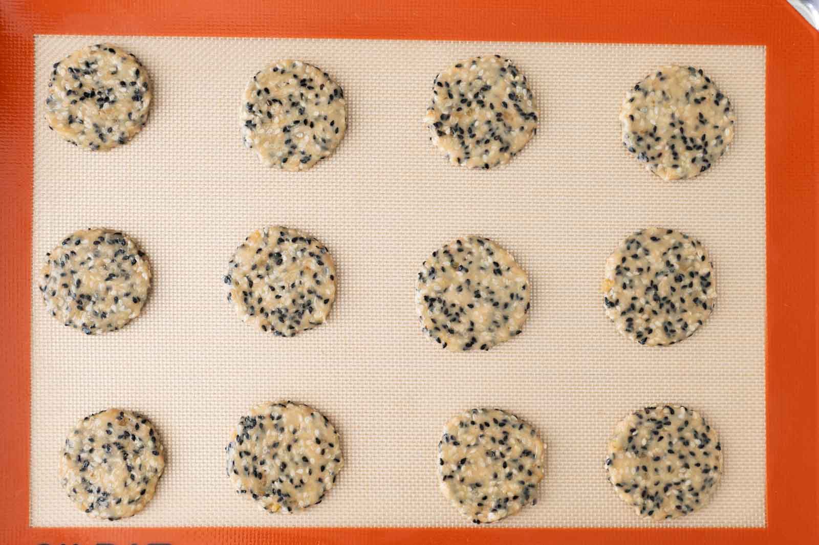 Flattened cookie dough over a silicone mat